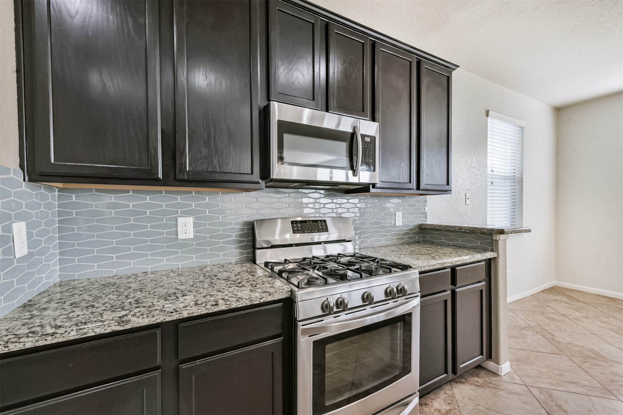 1305 Pinto Pass Alvin, TX 77511 - Photo 15 of 40 a kitchen with granite countertop stainless steel appliances and cabinets