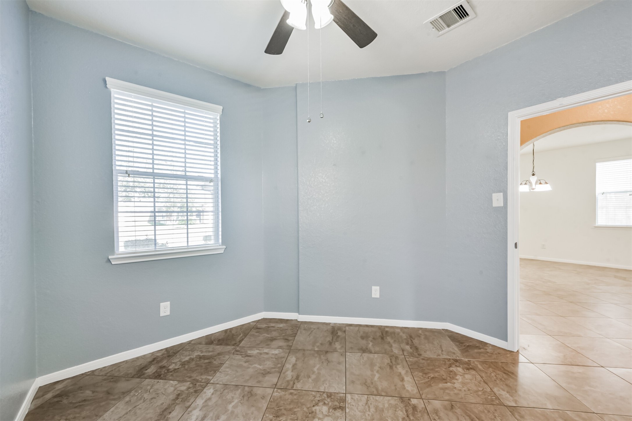 1305 Pinto Pass Alvin, TX 77511 - Photo 20 of 40 a view of an empty room with window and chandelier fan