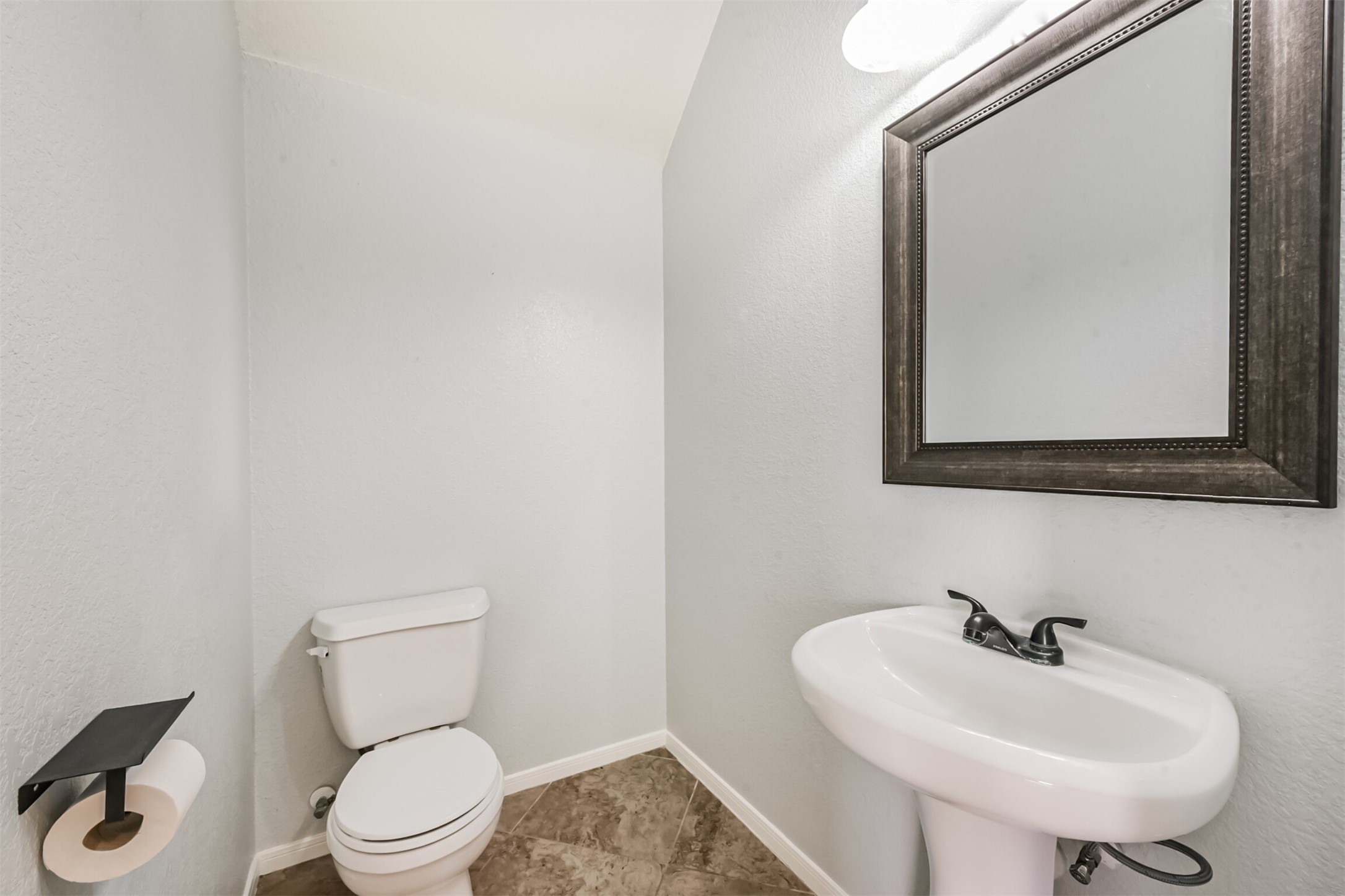 1305 Pinto Pass Alvin, TX 77511 - Photo 21 of 40 a bathroom with a toilet sink and mirror
