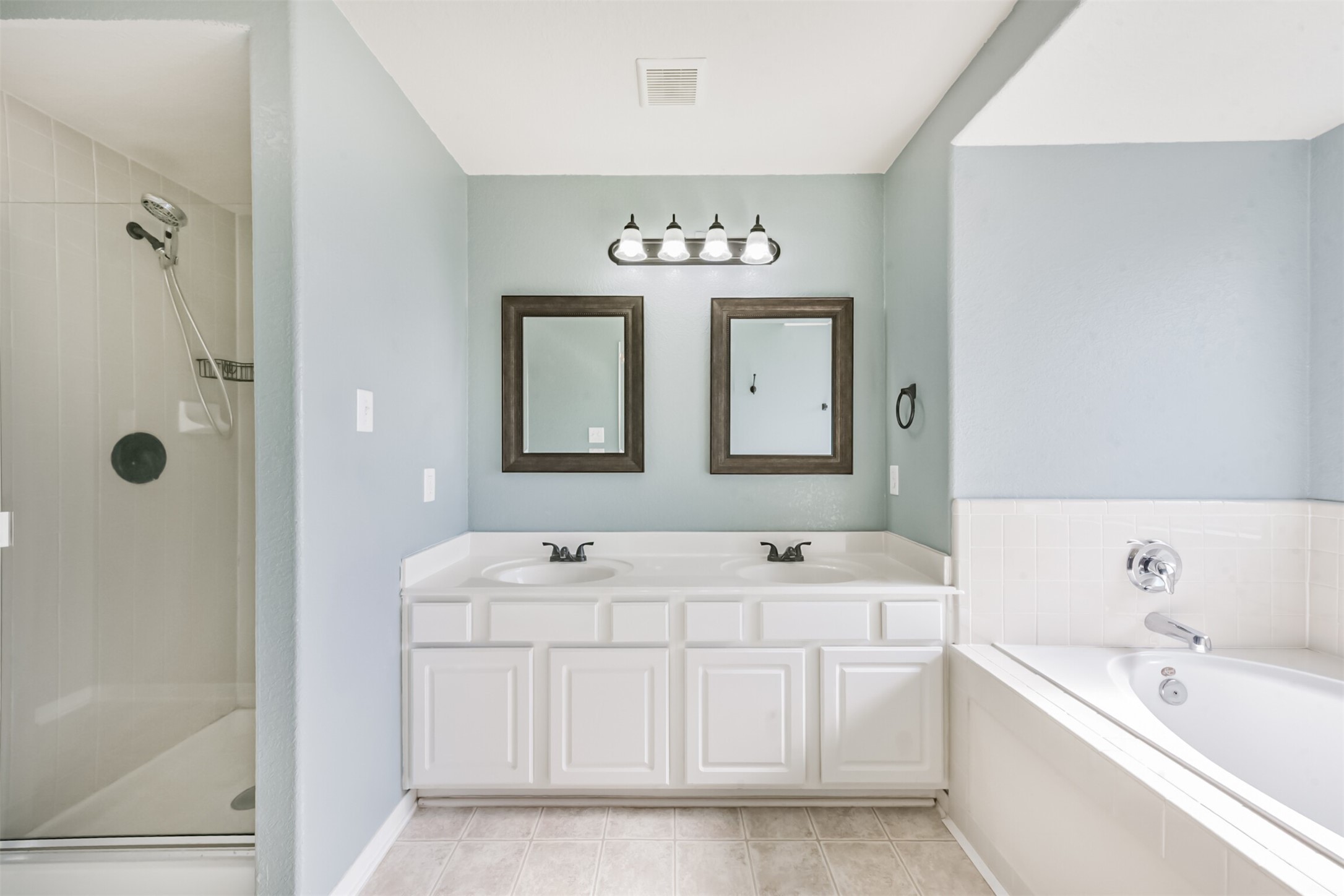 1305 Pinto Pass Alvin, TX 77511 - Photo 24 of 40 a bathroom with a double vanity sink mirror and bathtub