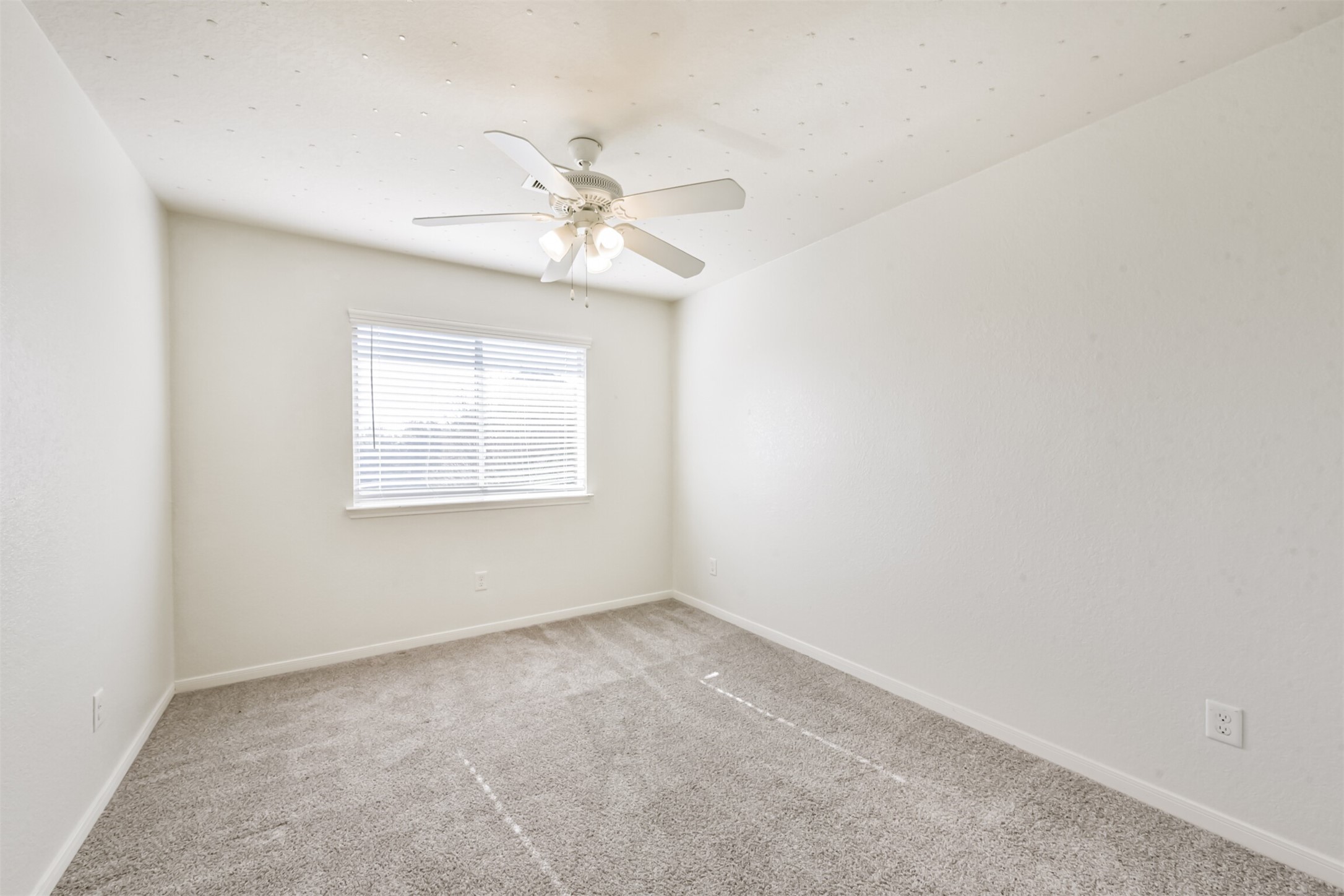 1305 Pinto Pass Alvin, TX 77511 - Photo 28 of 40 an empty room with a window and a fan