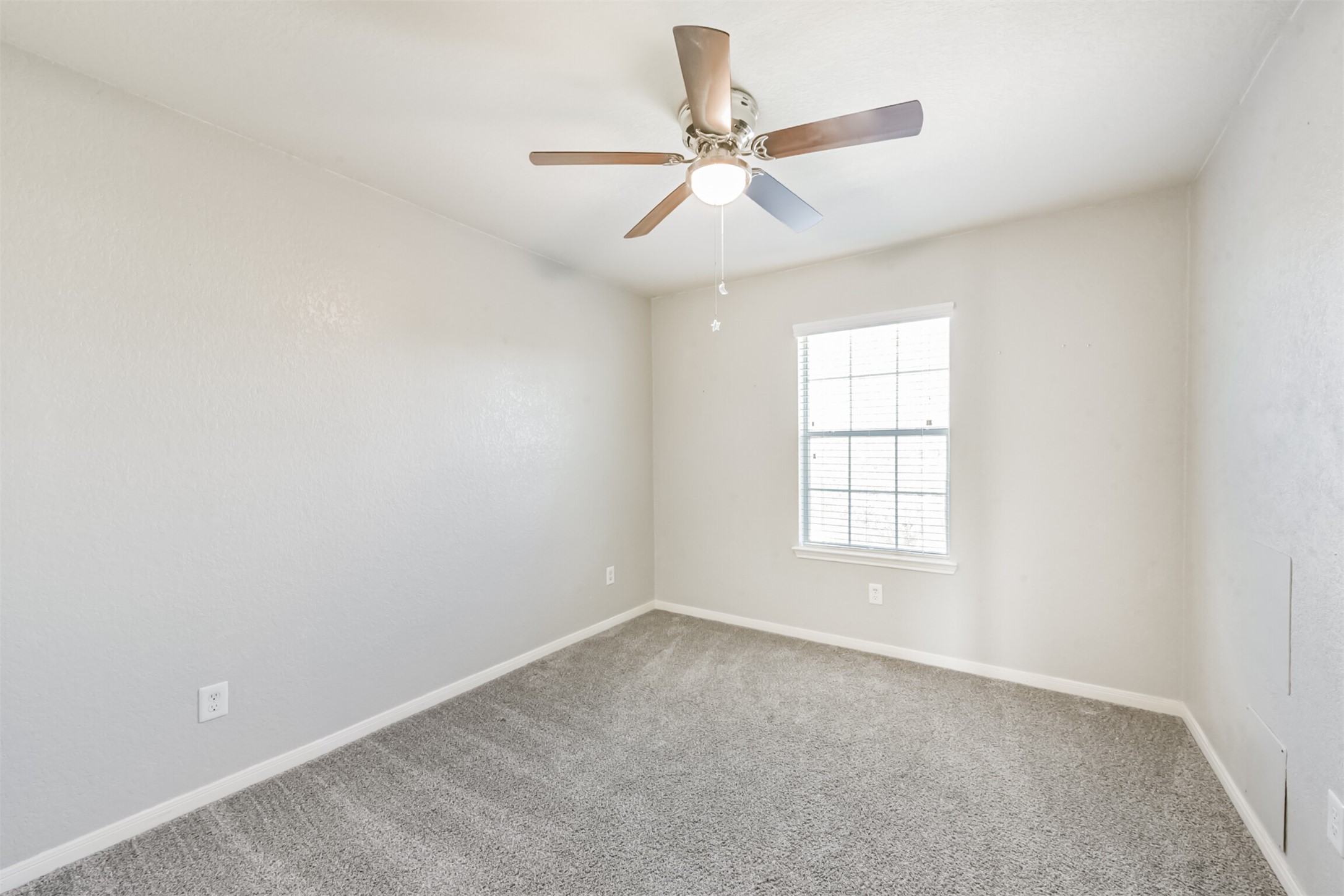 1305 Pinto Pass Alvin, TX 77511 - Photo 30 of 40 an empty room with a window and a fan