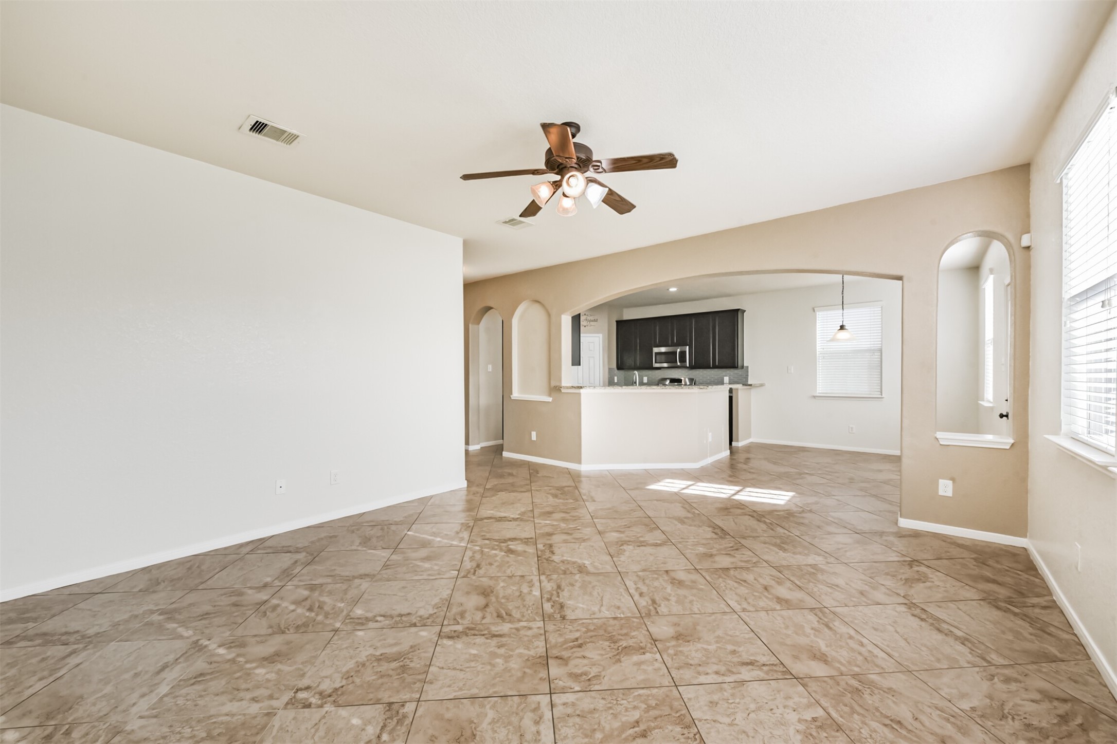 1305 Pinto Pass Alvin, TX 77511 - Photo 8 of 40 a view of a kitchen with a sink and a refrigerator