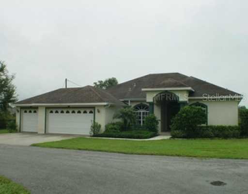 7404 County Line Road Odessa, FL 33556 - Photo 1 of 1 a front view of a house with a garden