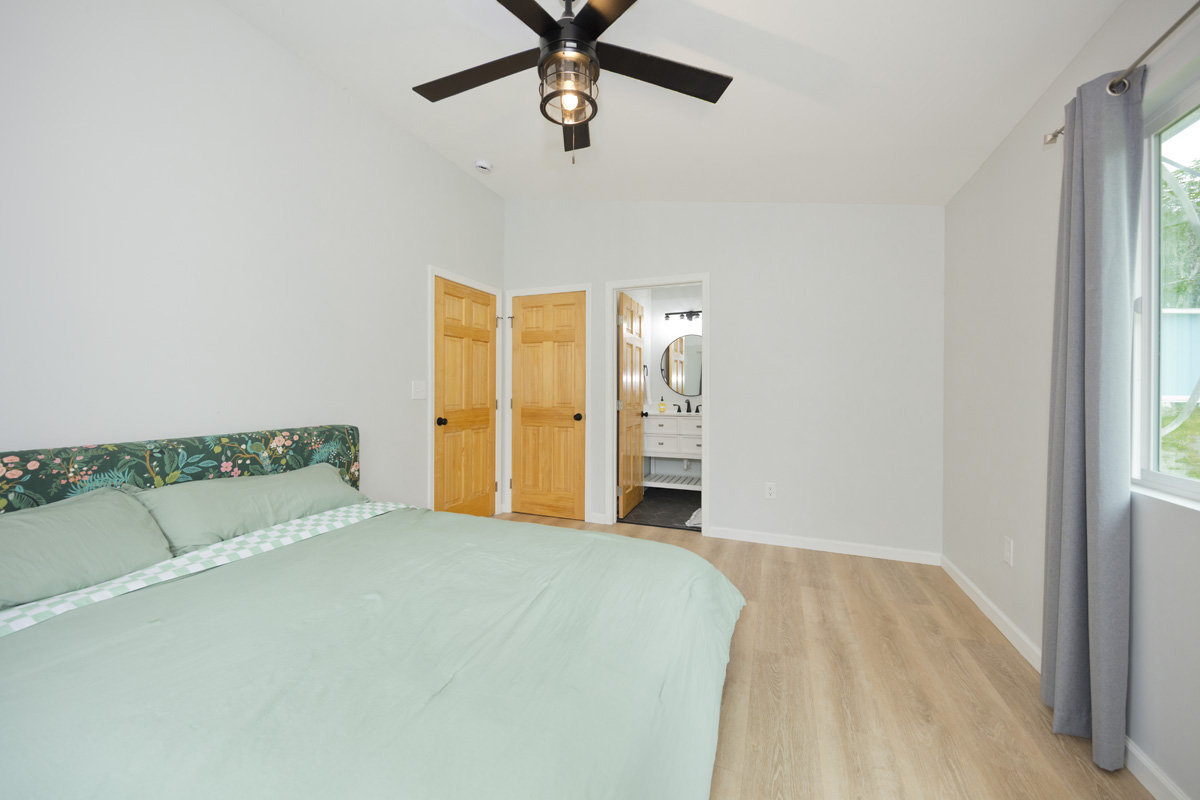87-2451 Hawaiʻi Belt Road Captain Cook, HI 96704 - Photo 12 of 30 a view of a bedroom with a bed and ceiling fan