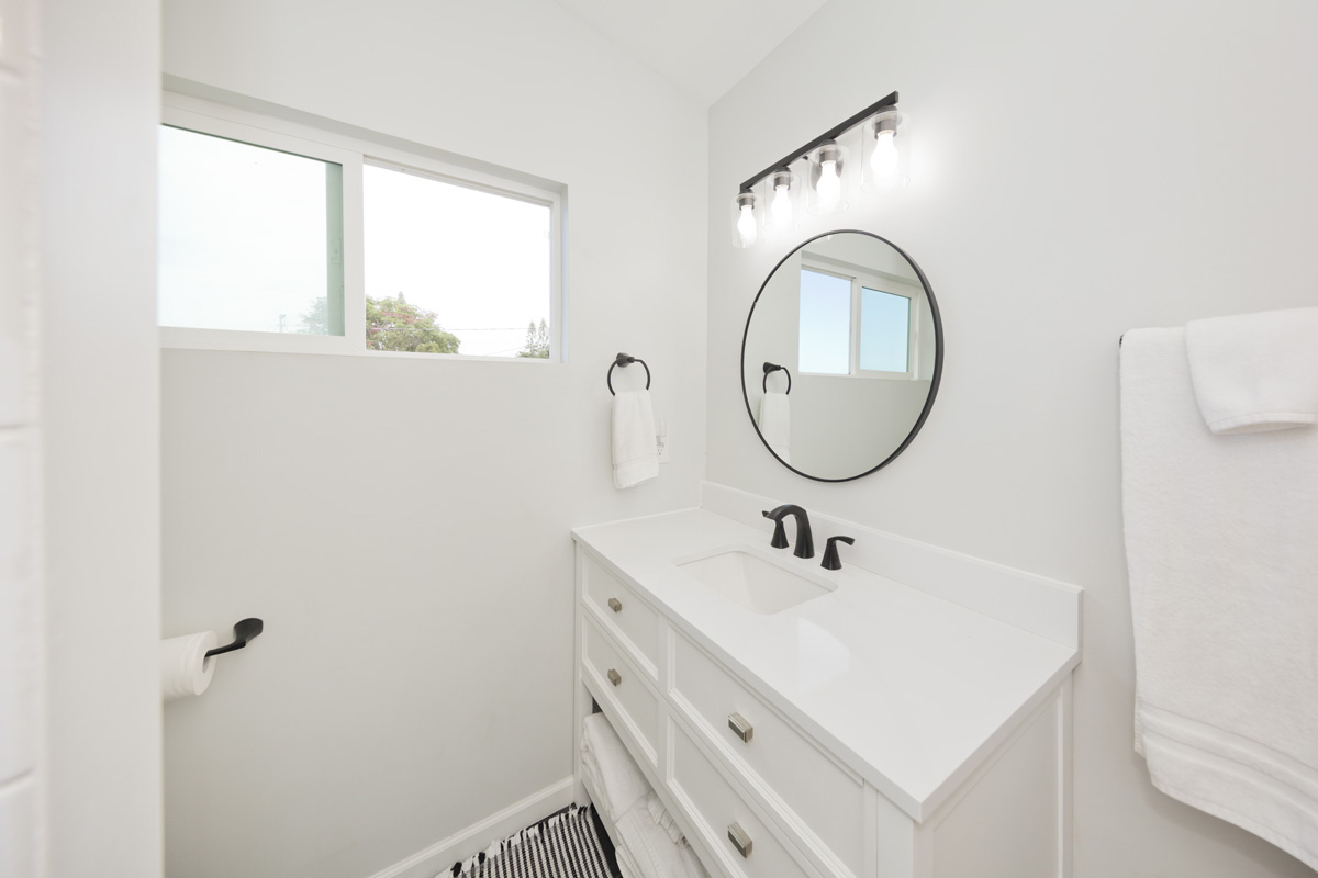 87-2451 Hawaiʻi Belt Road Captain Cook, HI 96704 - Photo 18 of 30 a bathroom with a sink and a mirror