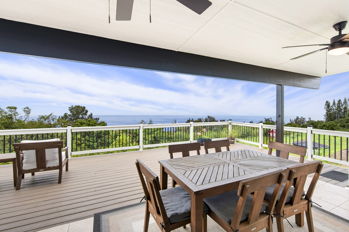 87-2451 Hawaiʻi Belt Road Captain Cook, HI 96704 - Photo 4 of 30 a view of a roof deck with table and chairs
