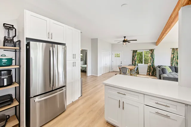 a kitchen with stainless steel appliances a refrigerator sink and cabinets