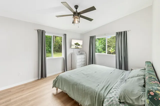 a bedroom with a bed and a large window