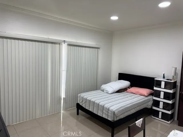 a bedroom with a bed and a cabinet