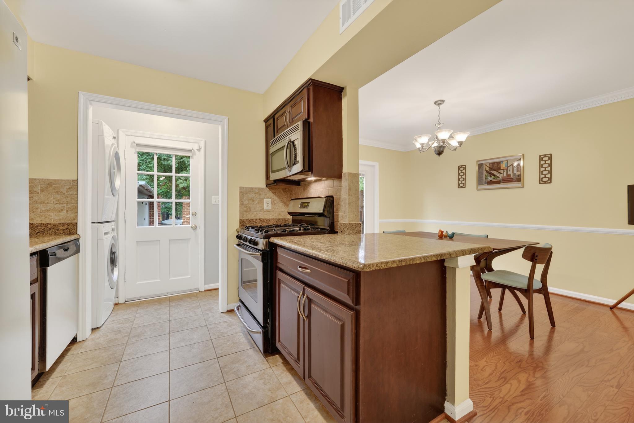 8139 Carrleigh Parkway Springfield, VA 22152 - Photo 10 of 27 a kitchen with a cabinets and chairs