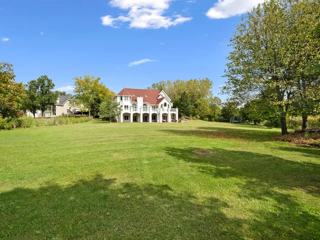 a living room with a fireplace furniture and a large window