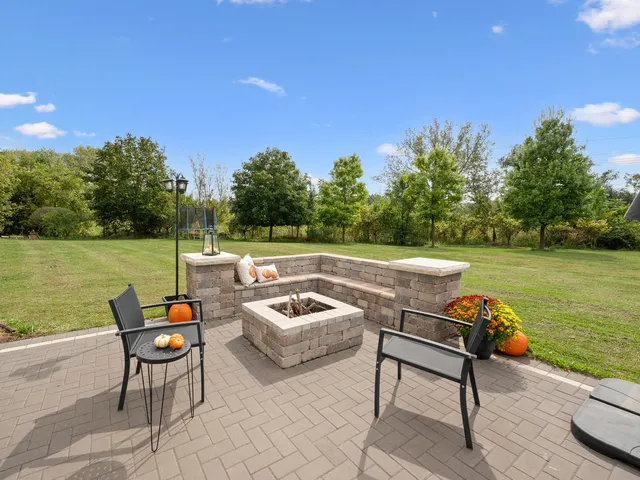 a view of a living room kitchen with stainless steel appliances wooden floor and living room
