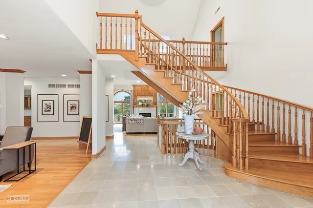 a dining room with furniture a fireplace and wooden floor