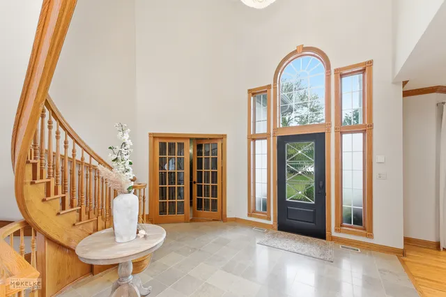 a living room with a fireplace windows and a fireplace