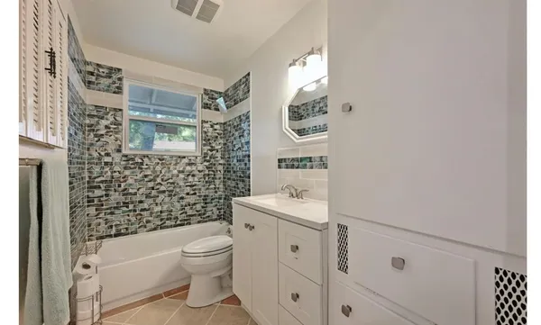 a bathroom with a toilet sink and shower