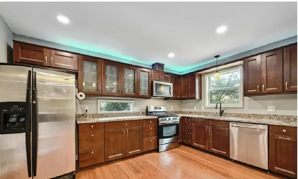 a kitchen with a sink a window and stainless steel appliances