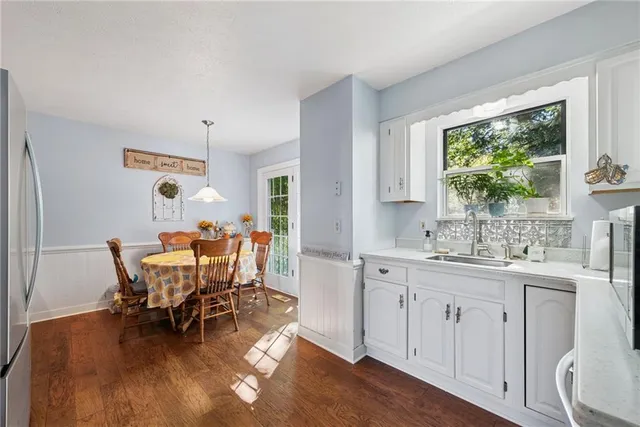 a dining room with furniture and wooden floor