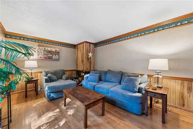 a living room with furniture and a lamp