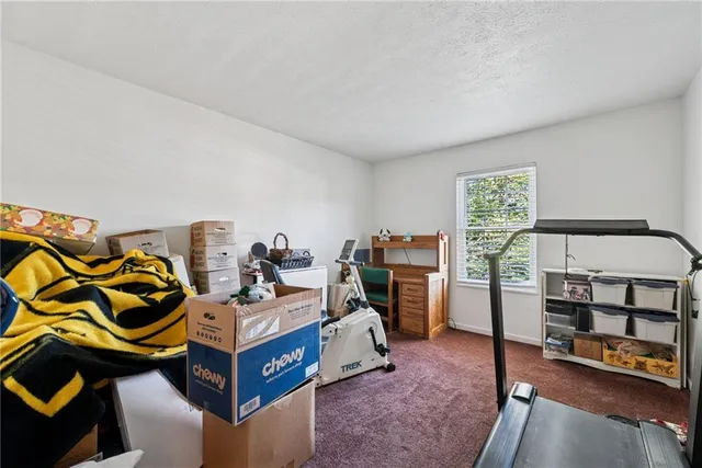 a bedroom with furniture and a gym equipment
