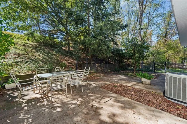 a view of a yard with wooden fence