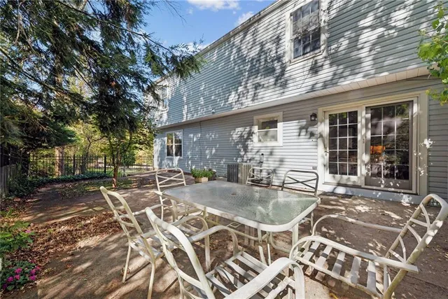 a view of a patio with table and chairs and potted plants