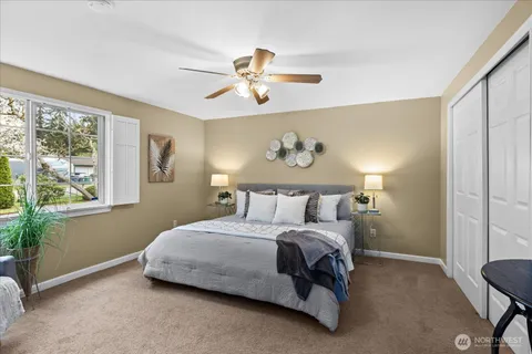 a bedroom with a bed and ceiling fan