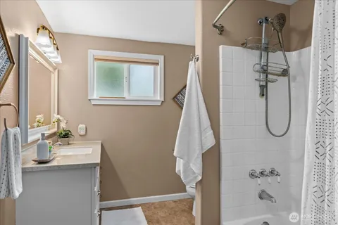 a en suite bathroom with a granite countertop sink and a mirror