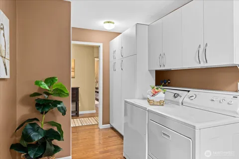 a living room with furniture flowerpot and wooden floor