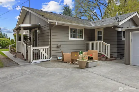 a view of a patio with furniture and wooden fence