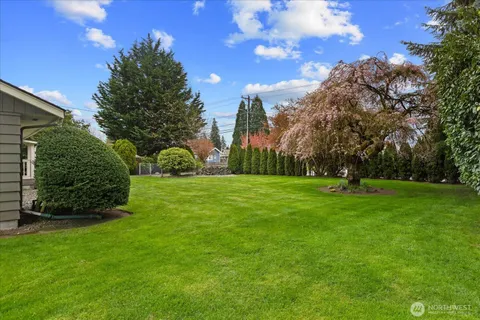 a front view of a house with a garden and yard