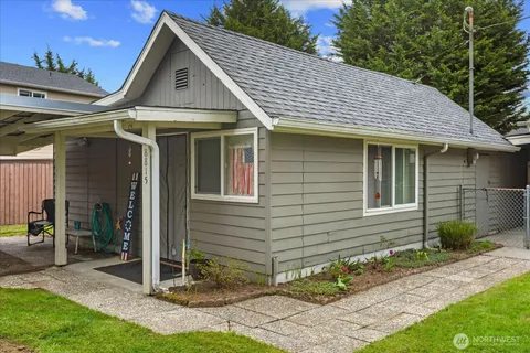 a front view of a house with a garden