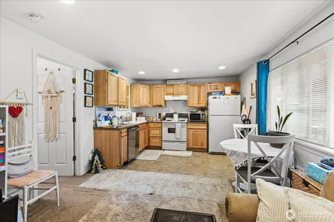 a kitchen with white cabinets and white appliances