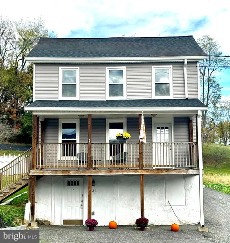 a front view of a house with lots of windows