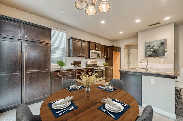 a kitchen with a refrigerator and a sink