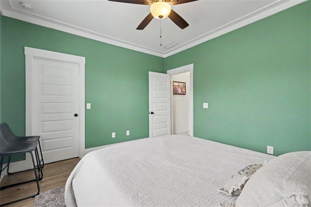 943 Clubside Drive Monroe, GA 30655 - Photo 36 of 93 a bedroom with a bed and a chandelier