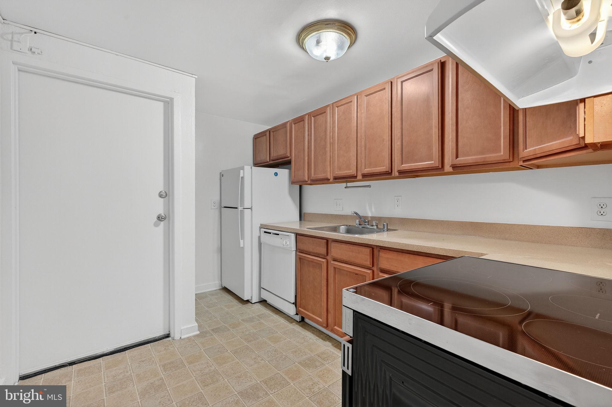 2441 18th Street Northwest, Unit 5 Washington, DC 20009 - Photo 13 of 23 a kitchen with stainless steel appliances granite countertop a refrigerator and a stove top oven