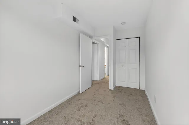 a view of an empty room and a window