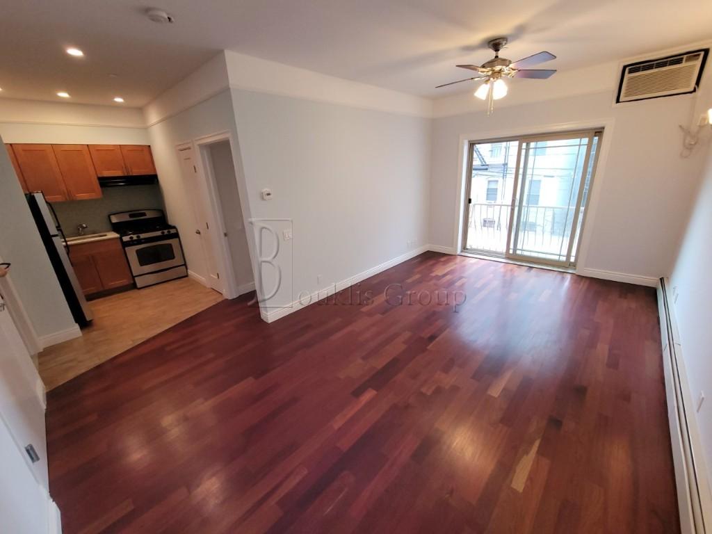 a view of a livingroom with hardwood floor and a ceiling fan