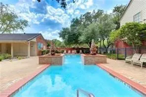 a swimming pool with outdoor seating and yard