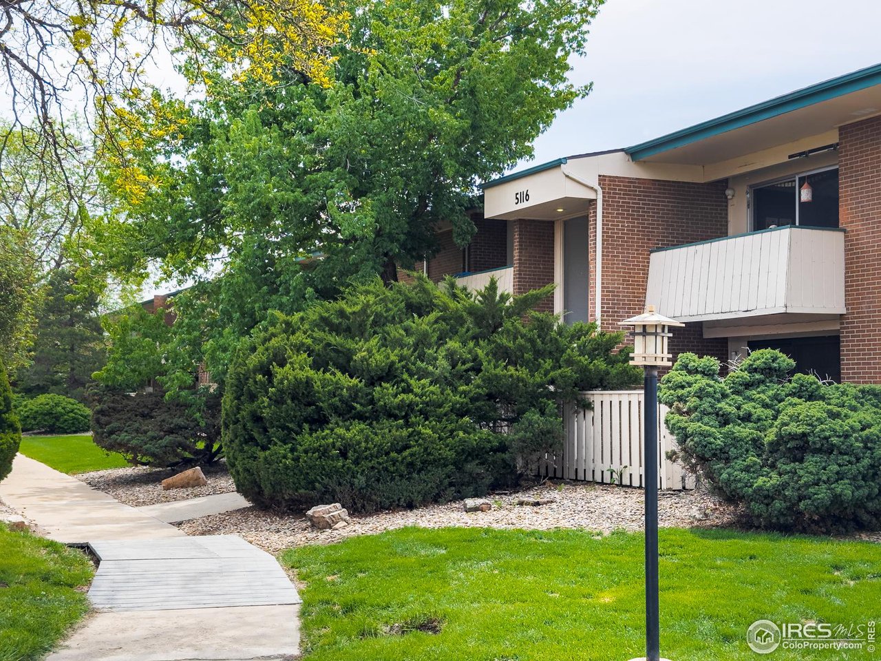 5116 Williams Fork Trail, Unit 103 Boulder, CO 80301 - Photo 1 of 20 a front view of a house with a yard