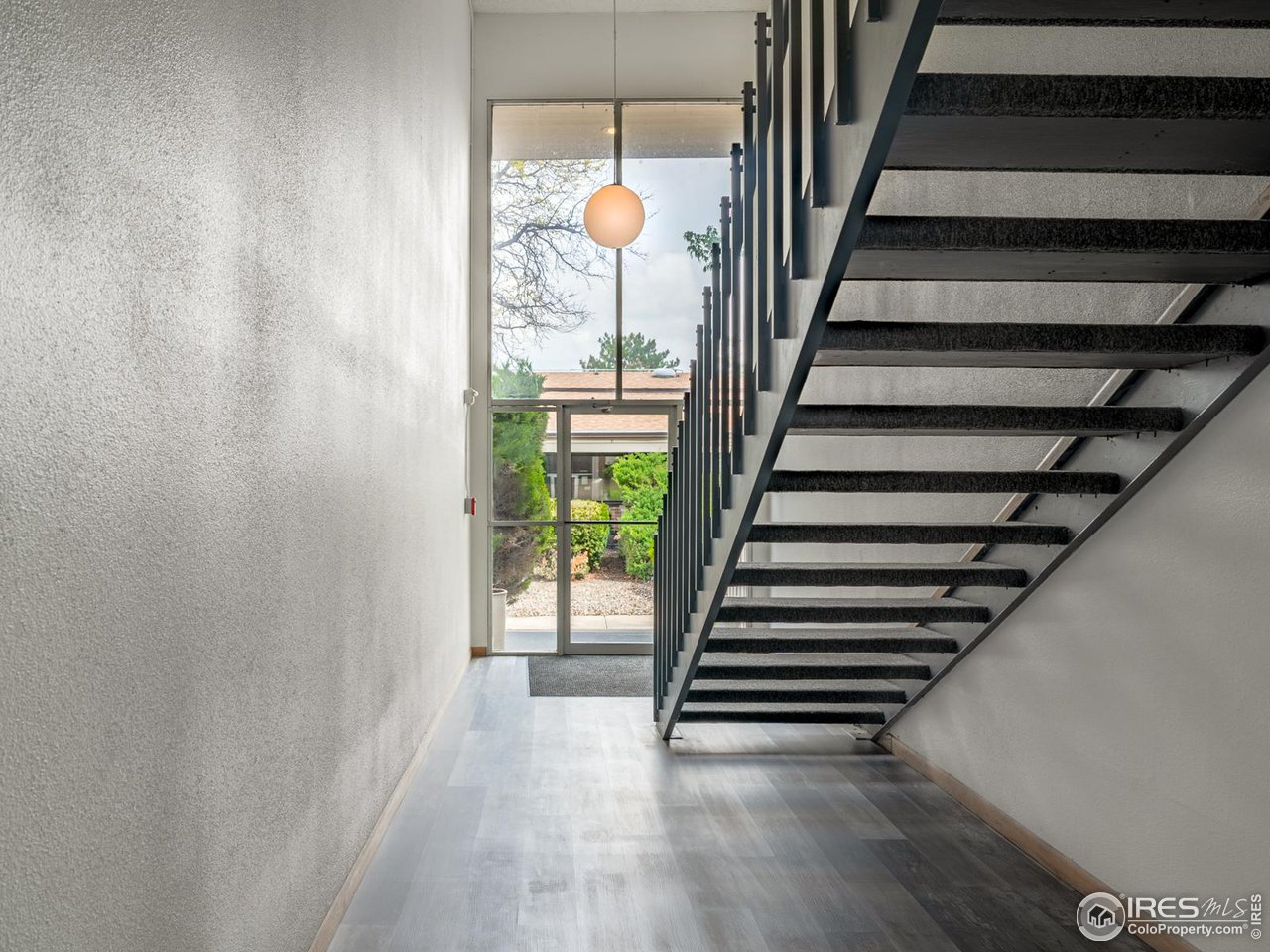 5116 Williams Fork Trail, Unit 103 Boulder, CO 80301 - Photo 2 of 20 a view of entryway with wooden floor and stairs