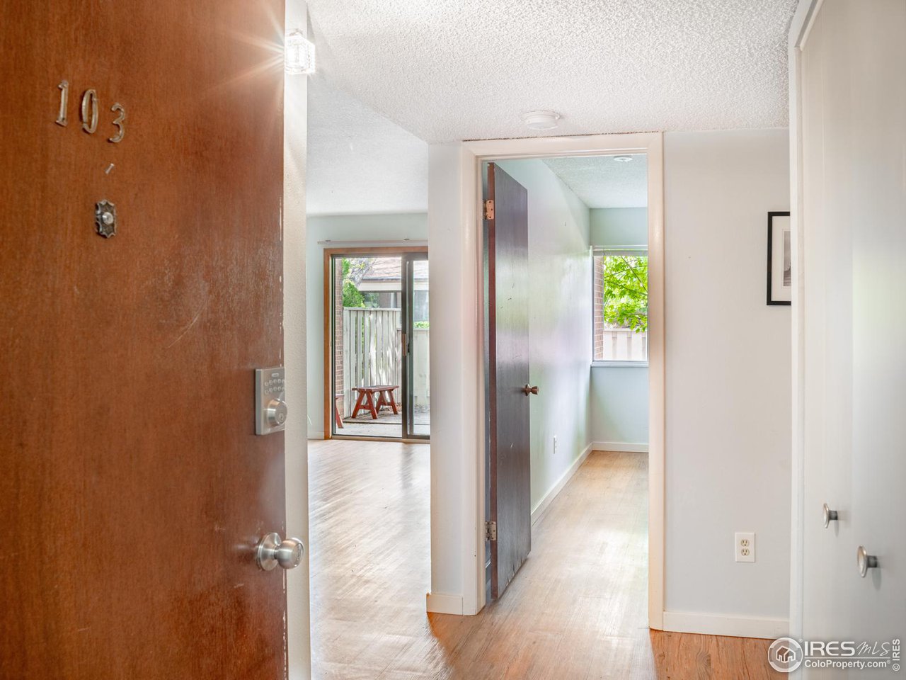 5116 Williams Fork Trail, Unit 103 Boulder, CO 80301 - Photo 3 of 20 a view of a hallway with wooden floor and a bathroom