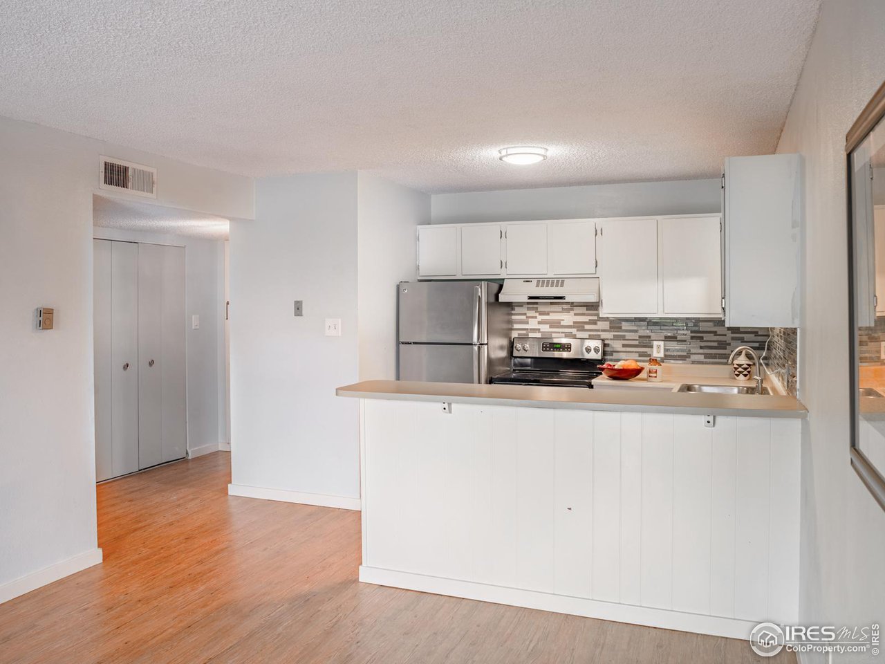 5116 Williams Fork Trail, Unit 103 Boulder, CO 80301 - Photo 6 of 20 a kitchen with stainless steel appliances granite countertop a refrigerator and a stove top oven