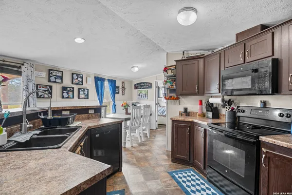 a kitchen with stainless steel appliances granite countertop a stove a sink dishwasher a refrigerator and a oven