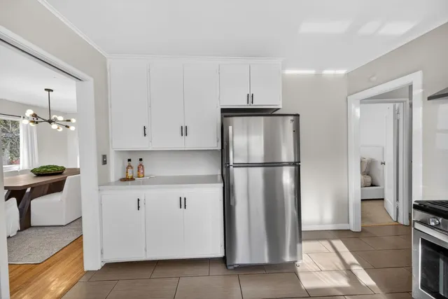 a kitchen with stainless steel appliances granite countertop a refrigerator and a stove