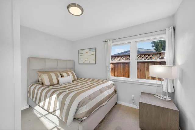 a bed room with a bed and a window