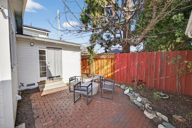 a backyard of a house with table and chairs
