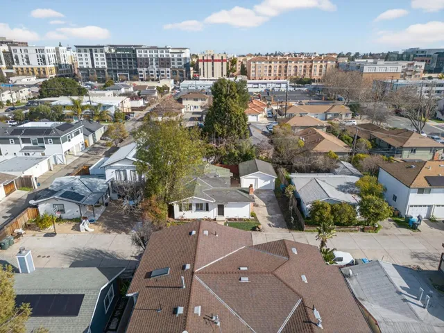an aerial view of a house with a yard basket ball court and outdoor seating