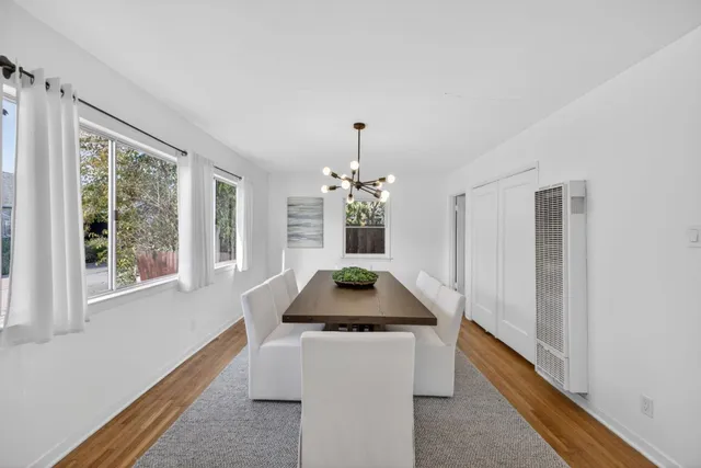 a kitchen with granite countertop white cabinets and window